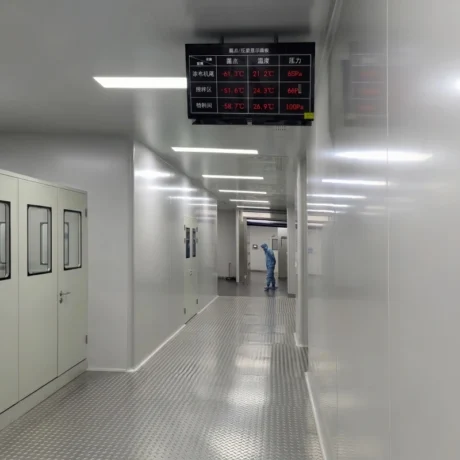 Internal passage inside clean & dry dehumidification room, overhead multi-area digital monitor panel displays real-time dew point (-51.6℃ ~ -61.3℃), temperature and pressure difference data for coating, mixing and material storage zones, stable ultra-low humidity environment for lithium ion, solid state and sodium ion battery production lines, full turnkey OEM dry room EPC project matched with FXD low dew point desiccant rotor dehumidifier